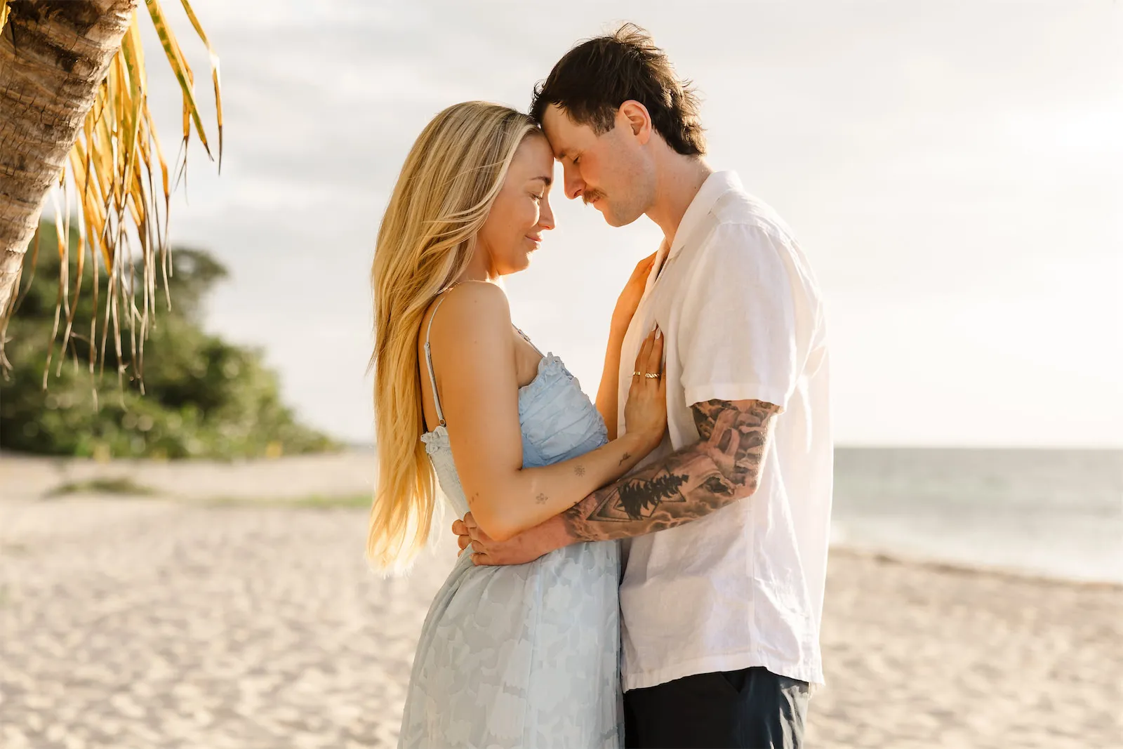 A couple posing together on a sandy Cozumel beach during a photo session