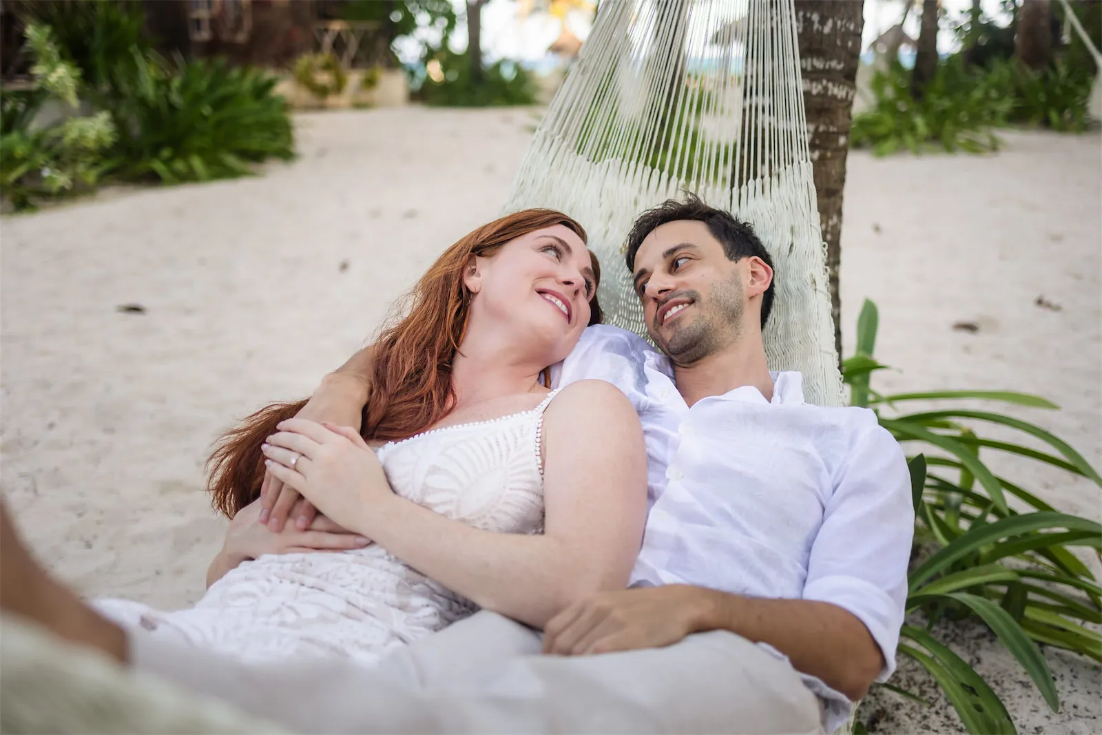 Couple relaxing in a hammock during a photo session in Cozumel