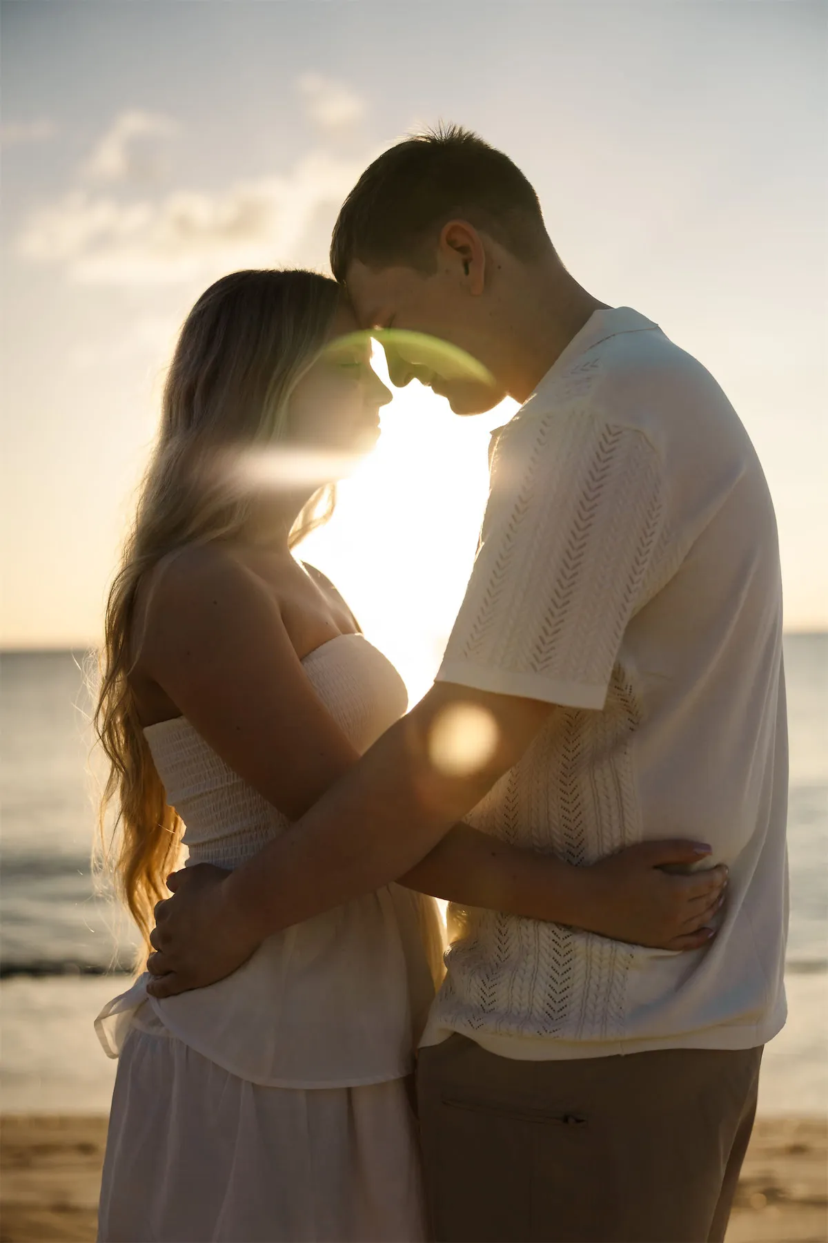 Couple walking along the Cozumel shoreline at sunset