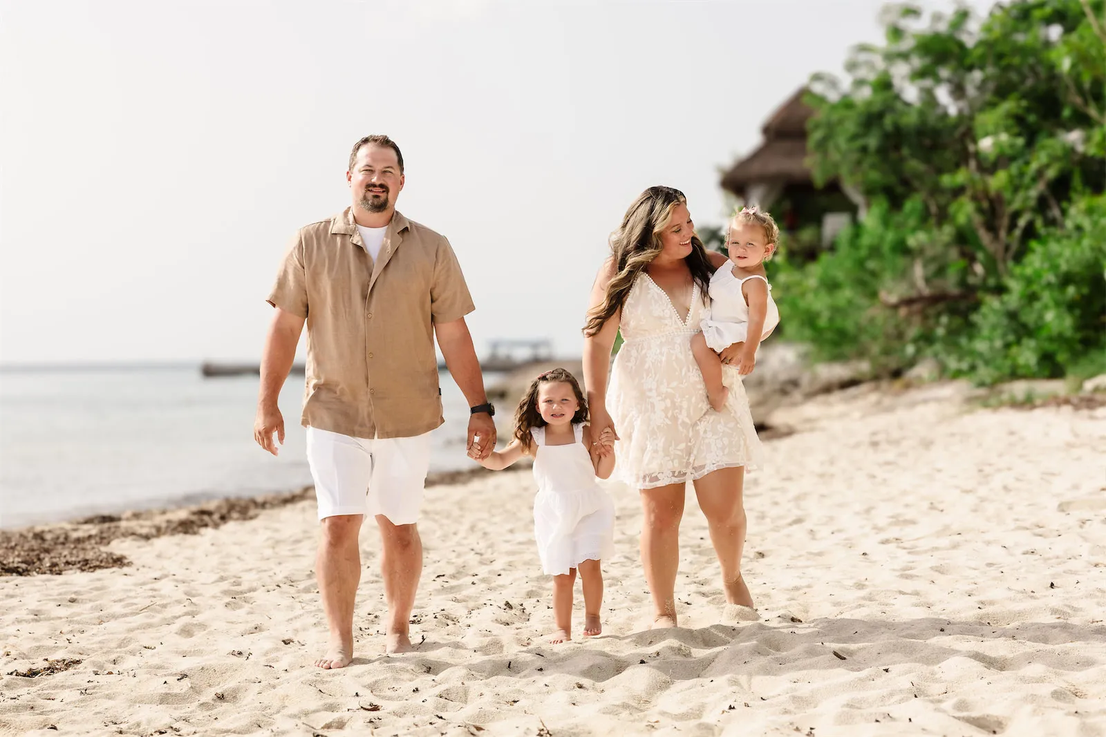 A family posing together on the beach at Dreams Natura resort in Cozumel