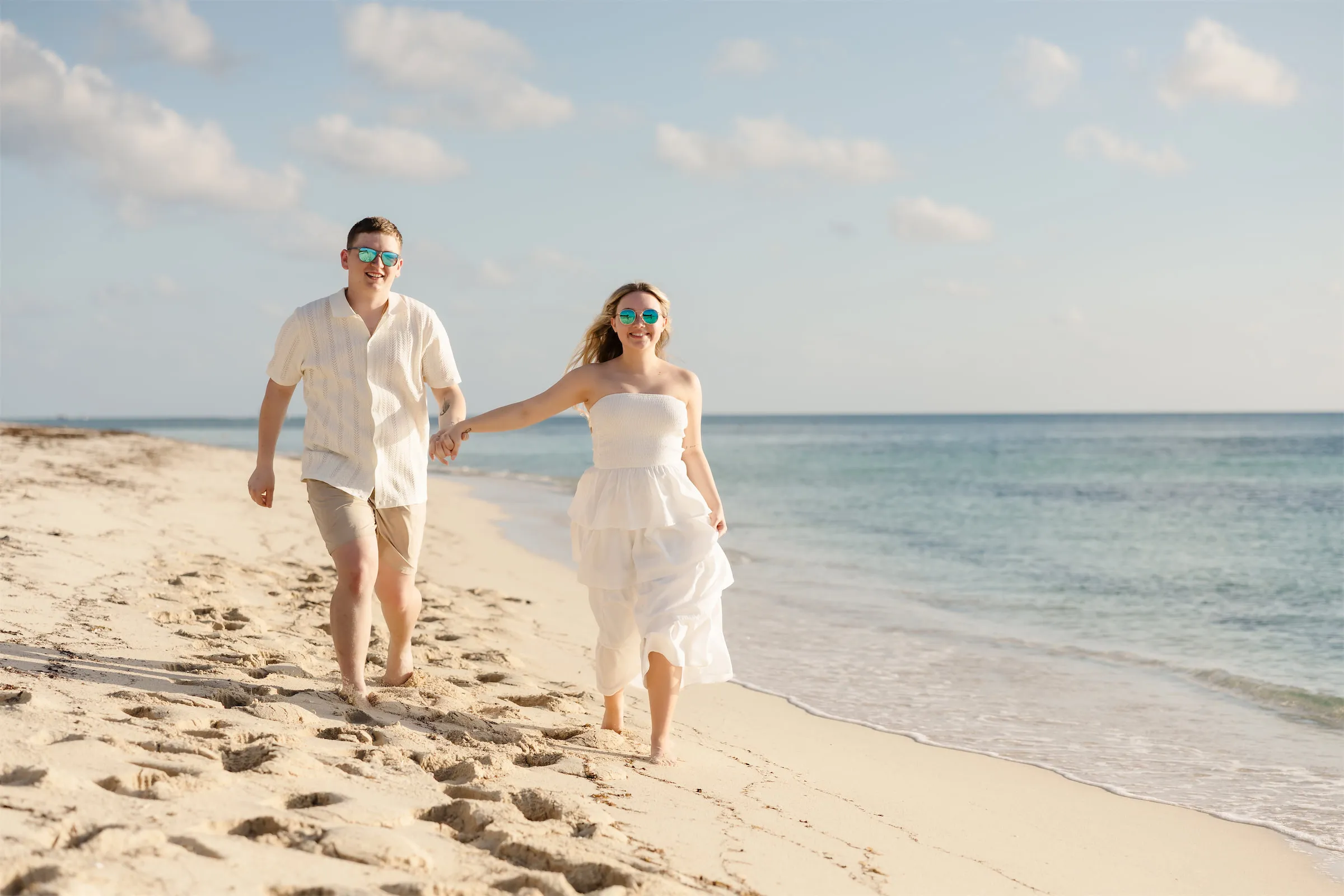 Family walking on Cozumel beach at golden hour