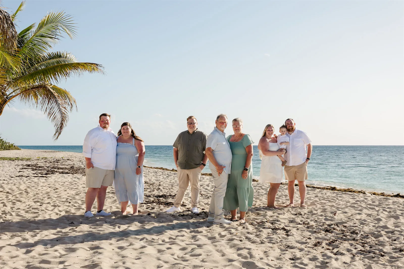 Large family group photo on a sandy Cozumel beach